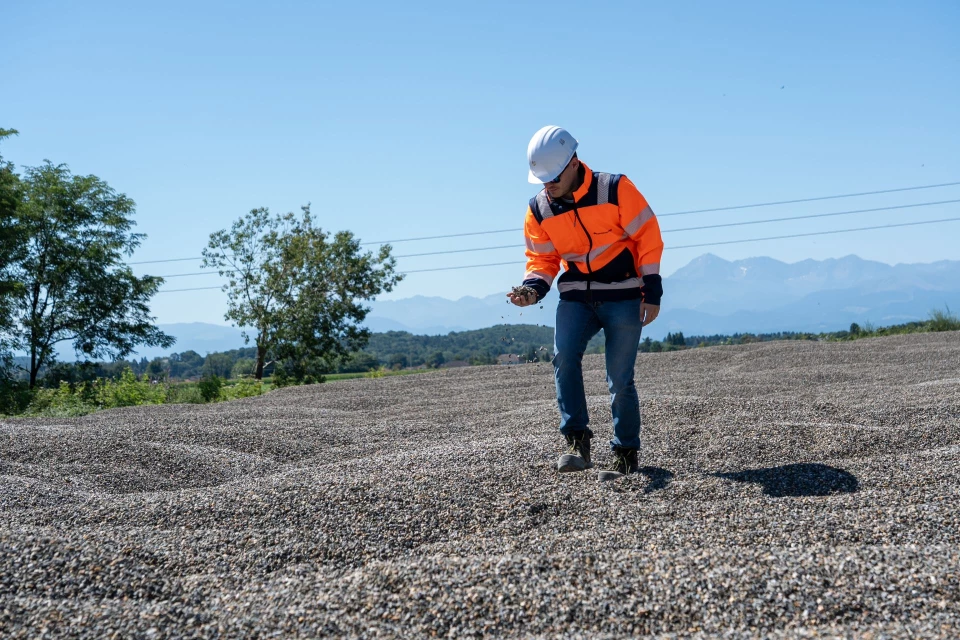 Technicien inspectant les granulats sur le site des carrières Malet.